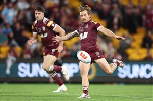 BRISBANE, AUSTRALIA - MAY 28: Cameron Munster of the Maroons kicks the ball through during game one of the Men