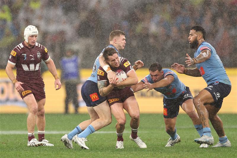 PERTH, AUSTRALIA - JUNE 18: Cameron Munster of the Maroons is tackled during game two of the Men
