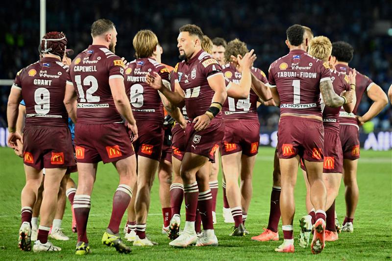 Maroons players celebrate a try during the final game three of the men