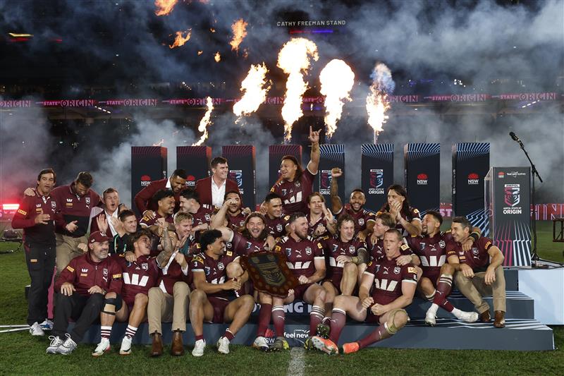SYDNEY, AUSTRALIA - JULY 09: Maroons players and staff celebrate with the State of Origin Shield after winning game three of the Men