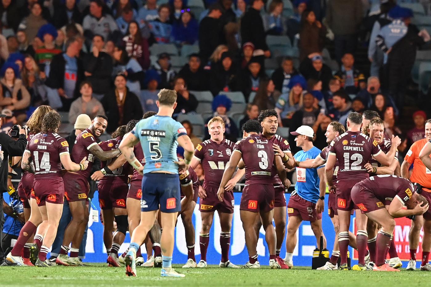 Maroons players celebrate their win in the final game three of the men