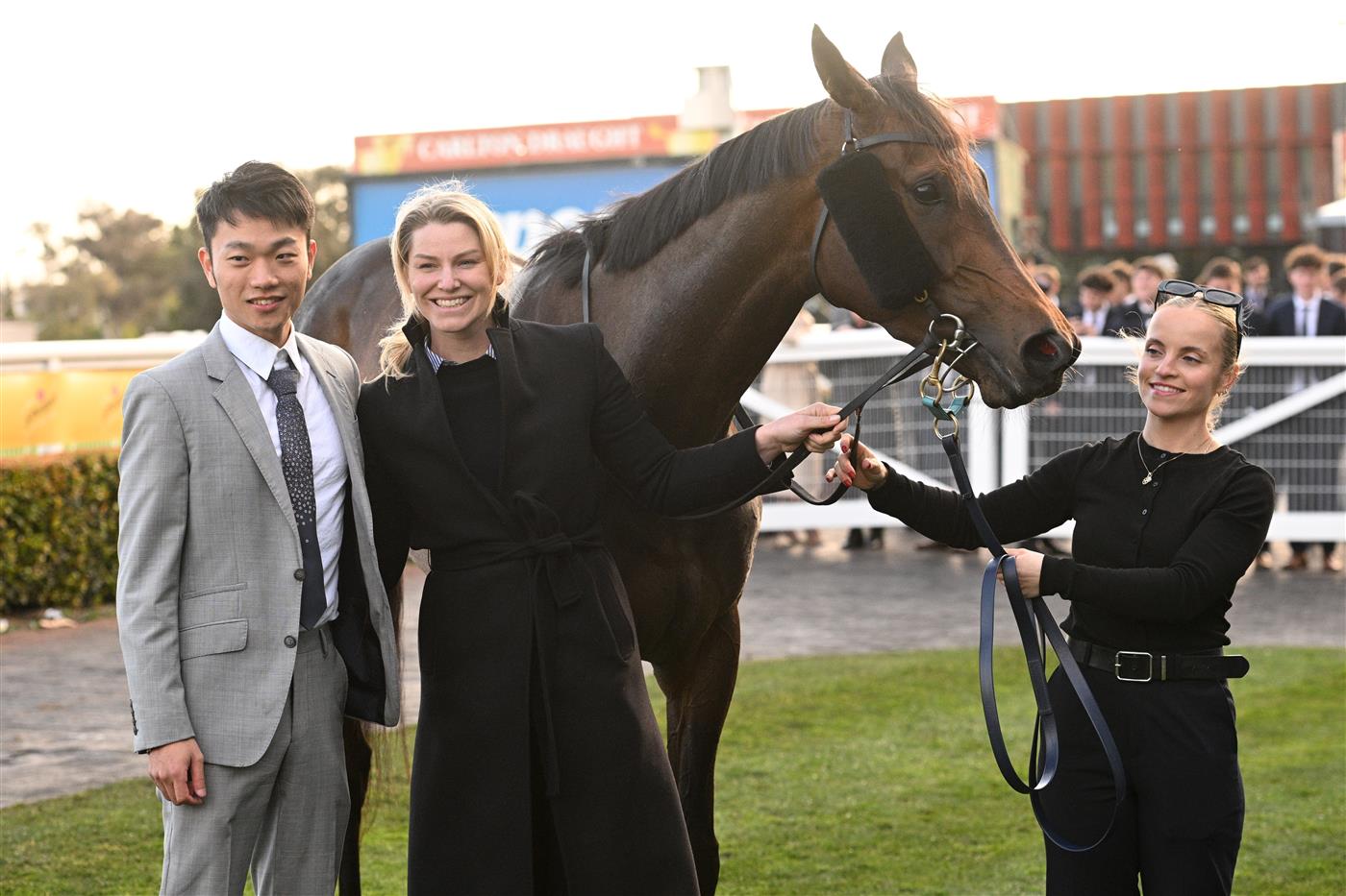 MELBOURNE, AUSTRALIA - AUGUST 30: Jun Zhang (Yulong) poses with Kate Laurie and Isabelle Eames after Treasurethe Moment won Race 9, the Stow Storage Memsie Stakes during Melbourne Racing at Caulfield Racecourse on August 30, 2025 in Melbourne, Australia. (Photo by Vince Caligiuri/Getty Images)