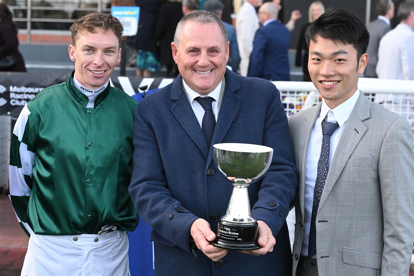 MELBOURNE, AUSTRALIA - AUGUST 30: Michael Dee poses with trainer Grahame Begg and owner Jun Zhang after riding Magic Time to win Race 8, the Evergreen Turf Cockram Stakes  during Melbourne Racing at Caulfield Racecourse on August 30, 2025 in Melbourne, Australia. (Photo by Vince Caligiuri/Getty Images)