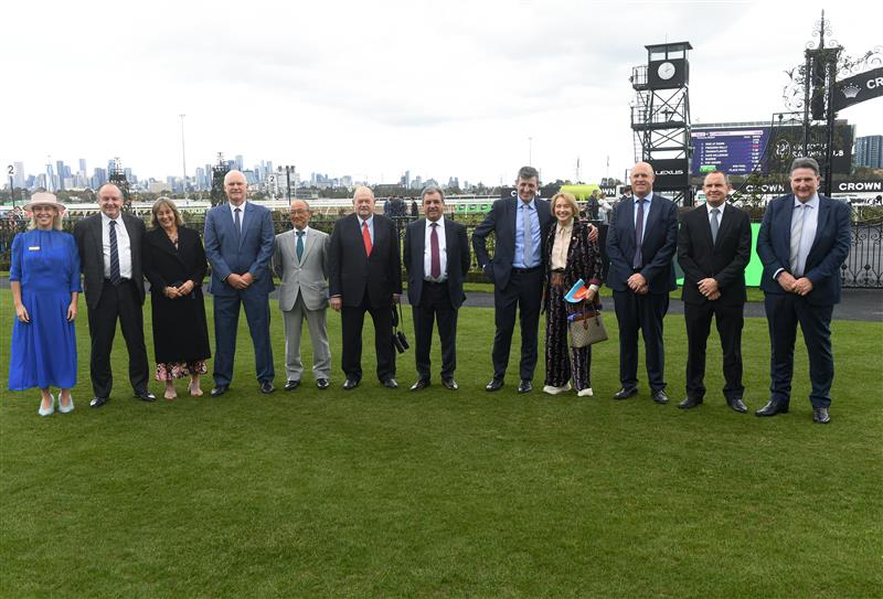 MELBOURNE, AUSTRALIA - SEPTEMBER 13: Kylie Rogers ( L)  poses for a group photo after presenting Melbourne Cup winning trainers and jockeys with Honorary memberships during Melbourne Racing at Flemington Racecourse on September 13, 2025 in Melbourne, Australia. (Photo by Vince Caligiuri/Getty Images)
