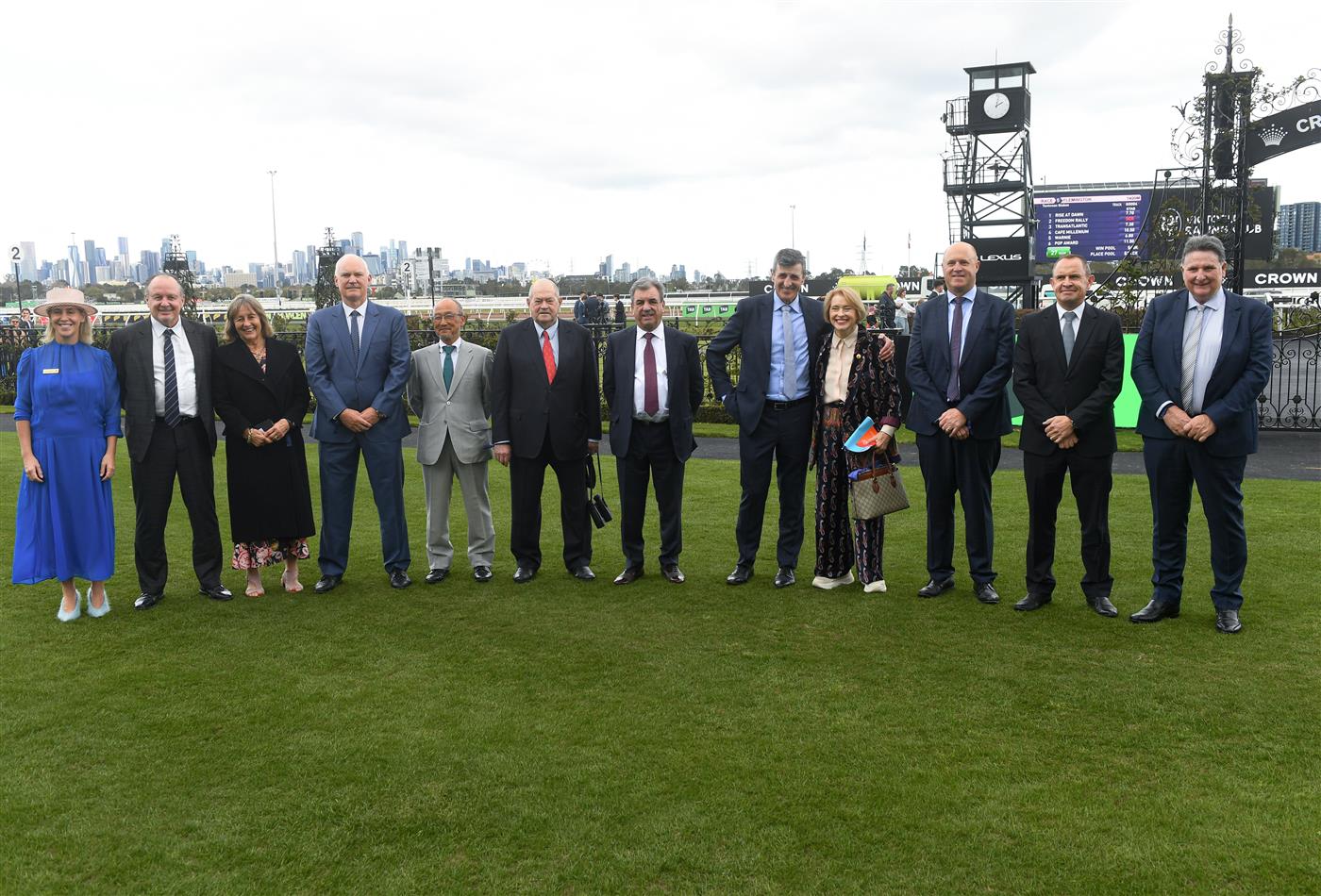 MELBOURNE, AUSTRALIA - SEPTEMBER 13: Kylie Rogers ( L)  poses for a group photo after presenting Melbourne Cup winning trainers and jockeys with Honorary memberships during Melbourne Racing at Flemington Racecourse on September 13, 2025 in Melbourne, Australia. (Photo by Vince Caligiuri/Getty Images)