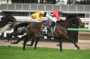 MELBOURNE, AUSTRALIA - SEPTEMBER 13: Declan Bates riding Revelare winning Race 7, the Lexus Archer Stakes during Melbourne Racing at Flemington Racecourse on September 13, 2025 in Melbourne, Australia. (Photo by Vince Caligiuri/Getty Images)