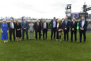 MELBOURNE, AUSTRALIA - SEPTEMBER 13: Kylie Rogers ( L)  poses for a group photo after presenting Melbourne Cup winning trainers and jockeys with Honorary memberships during Melbourne Racing at Flemington Racecourse on September 13, 2025 in Melbourne, Australia. (Photo by Vince Caligiuri/Getty Images)