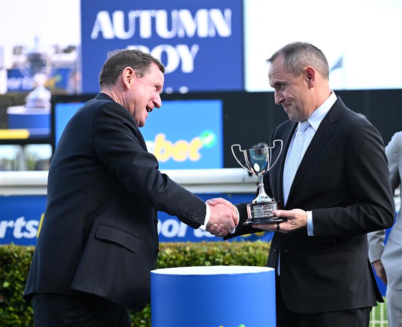 MELBOURNE, AUSTRALIA - OCTOBER 11: Trainer Chris Waller is presented the trophy from new MRC Chairman Cameron Fisher after Autumn Boy won Race 8, the Sportsbet Caulfield Guineas during Melbourne Racing at Caulfield Racecourse on October 11, 2025 in Melbourne, Australia. (Photo by Vince Caligiuri/Getty Images)