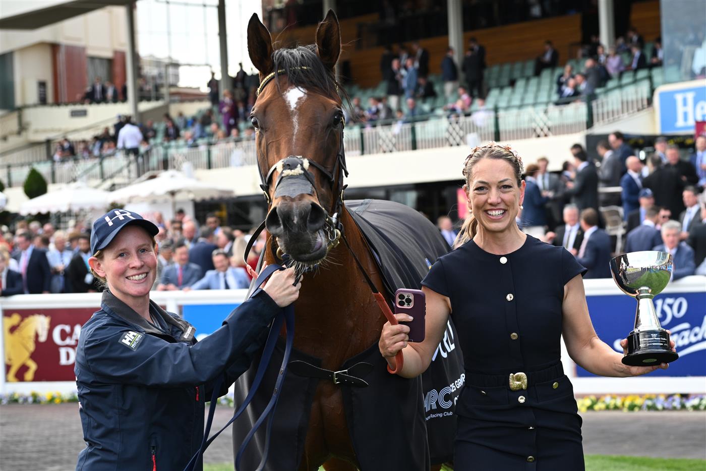 MELBOURNE, AUSTRALIA - OCTOBER 11: Trainer Charlotte Littlefield hugs She's Bulletproof after winning Race 10, the Northwood Plume Stakes. (Getty)