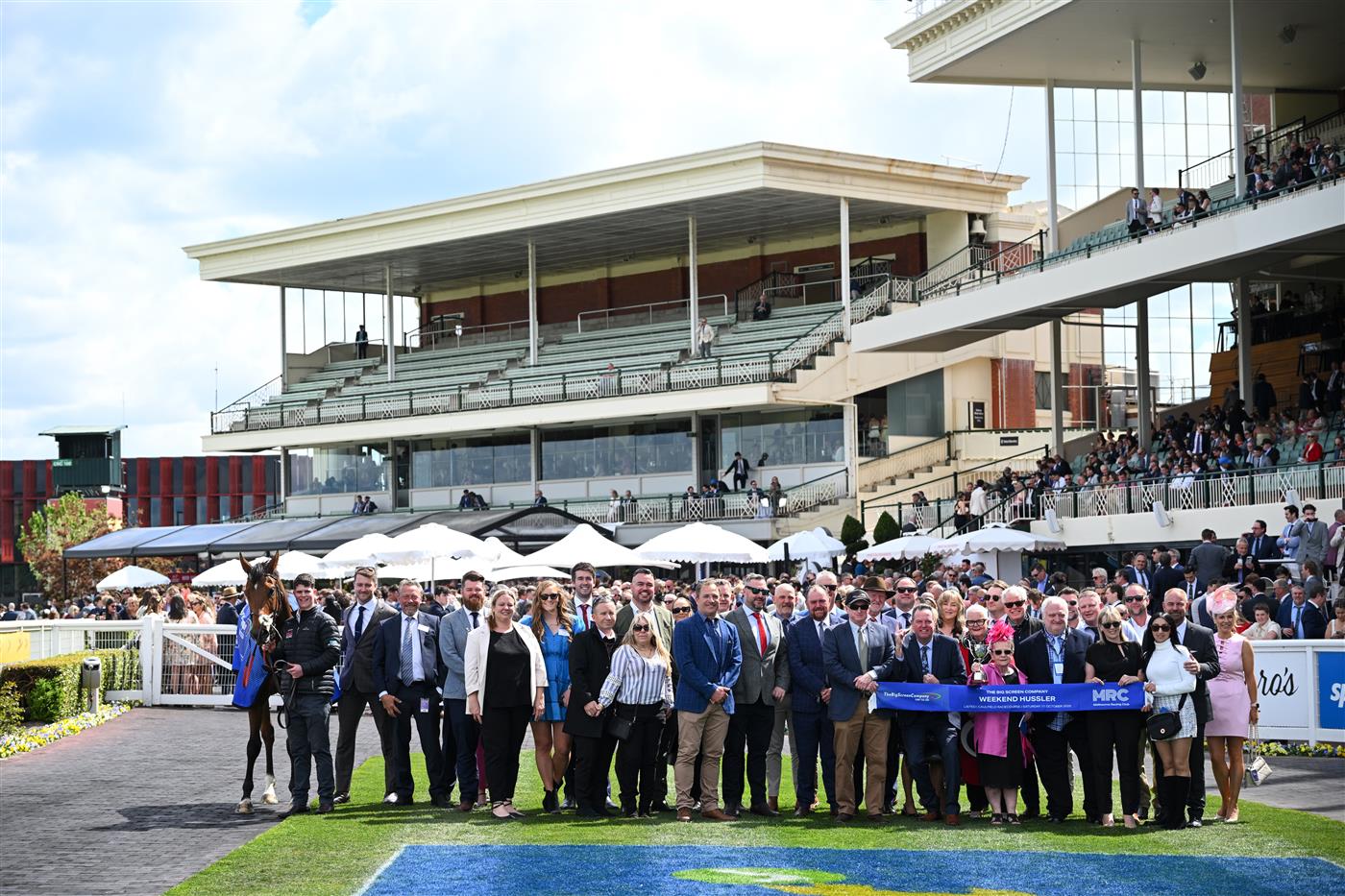 MELBOURNE, AUSTRALIA - OCTOBER 11:  Zou Sensation and winning connections after winning Race 5, the The Big Screen Company Weekend Hussler during Melbourne Racing at Caulfield Racecourse on October 11, 2025 in Melbourne, Australia. (Photo by Vince Caligiuri/Getty Images)