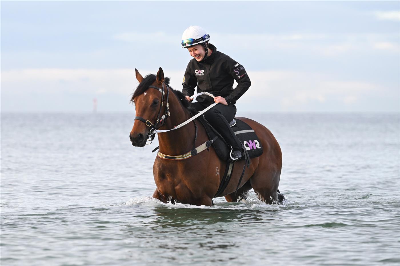 MELBOURNE, AUSTRALIA - OCTOBER 12: Lizzie Collett riding  Autumn Boy, winner of yesterdays Caulfield Guineas during a beach session at Altona Beach on October 12, 2025 in Melbourne, Australia. (Photo by Vince Caligiuri/Getty Images)