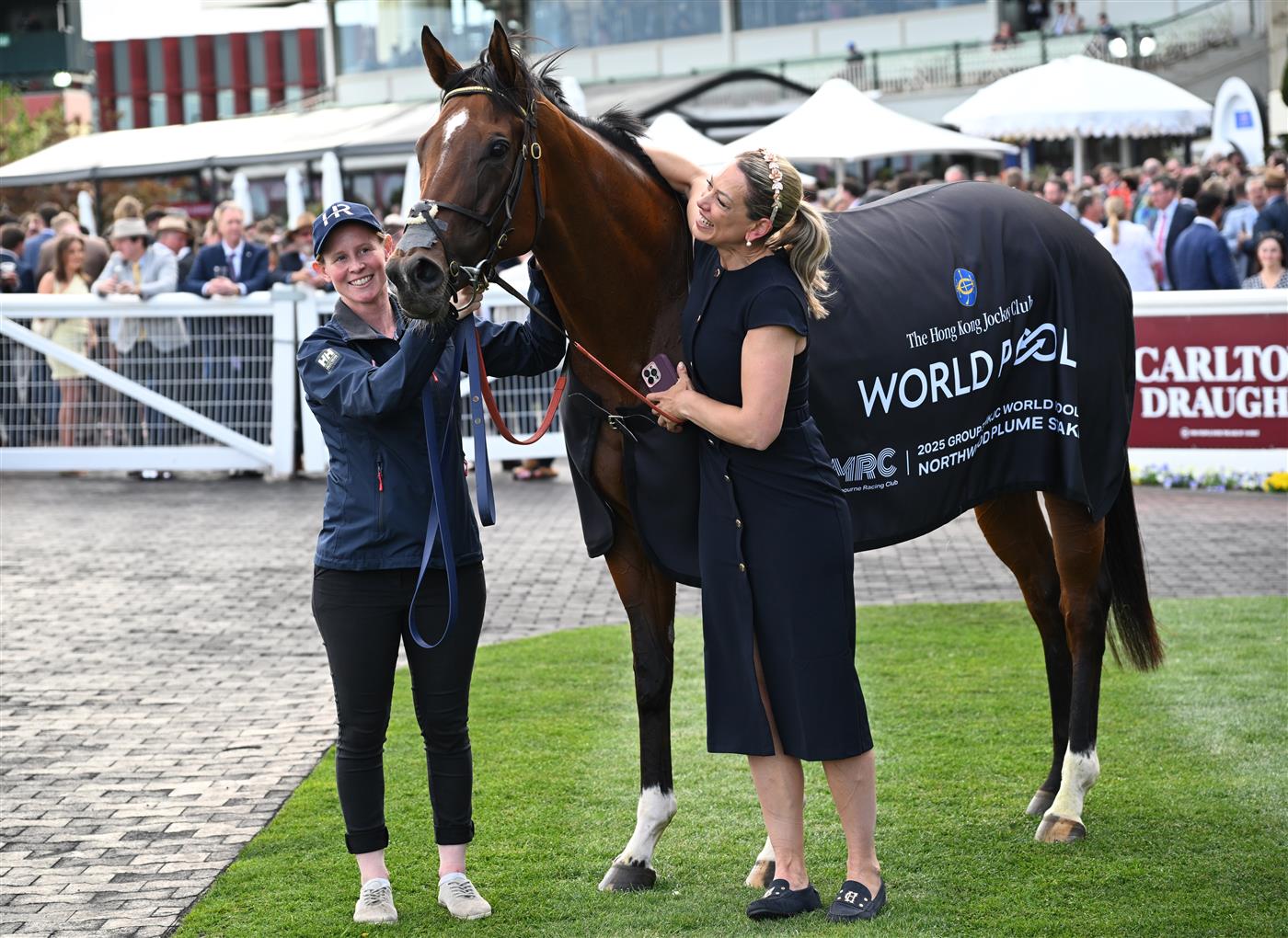 MELBOURNE, AUSTRALIA - OCTOBER 11: Trainer Charlotte Littlefield hugs She's Bulletproof after winning Race 10, the Northwood Plume Stakes. (Getty)
