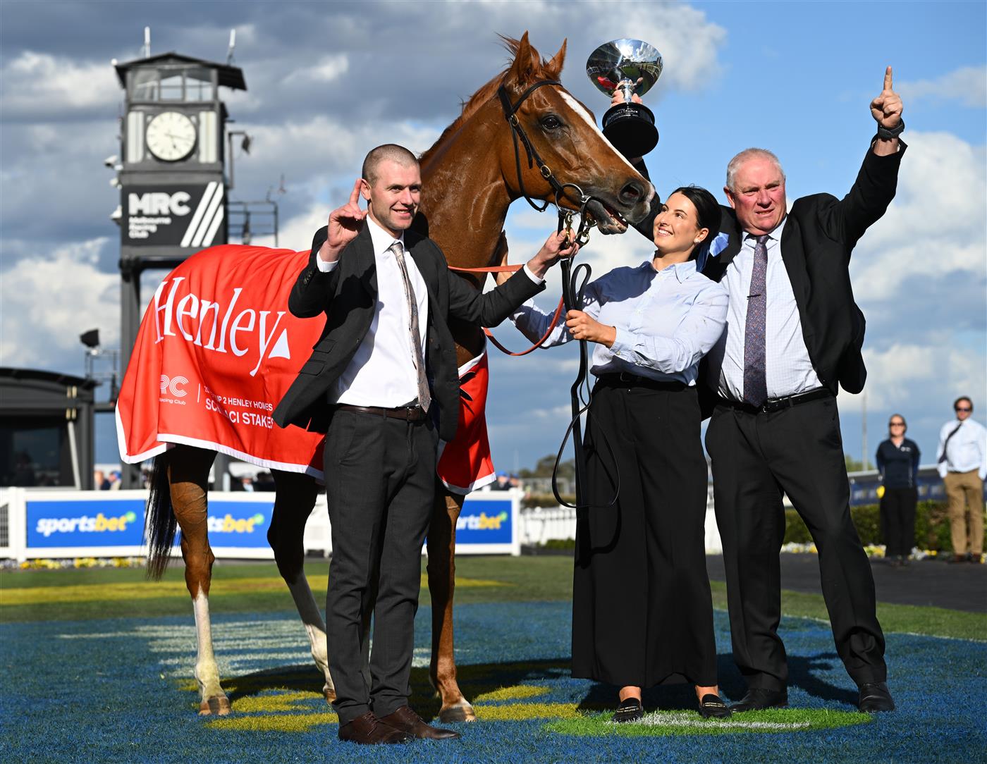 MELBOURNE, AUSTRALIA - OCTOBER 11: Trainer Clayton Douglas, Lydia Rigg-Floyd and Rod Douglas pose with Giga Kick after winning Race 9, the Henley Homes Schillaci Stakes during Melbourne Racing at Caulfield Racecourse on October 11, 2025 in Melbourne, Australia. (Photo by Vince Caligiuri/Getty Images)