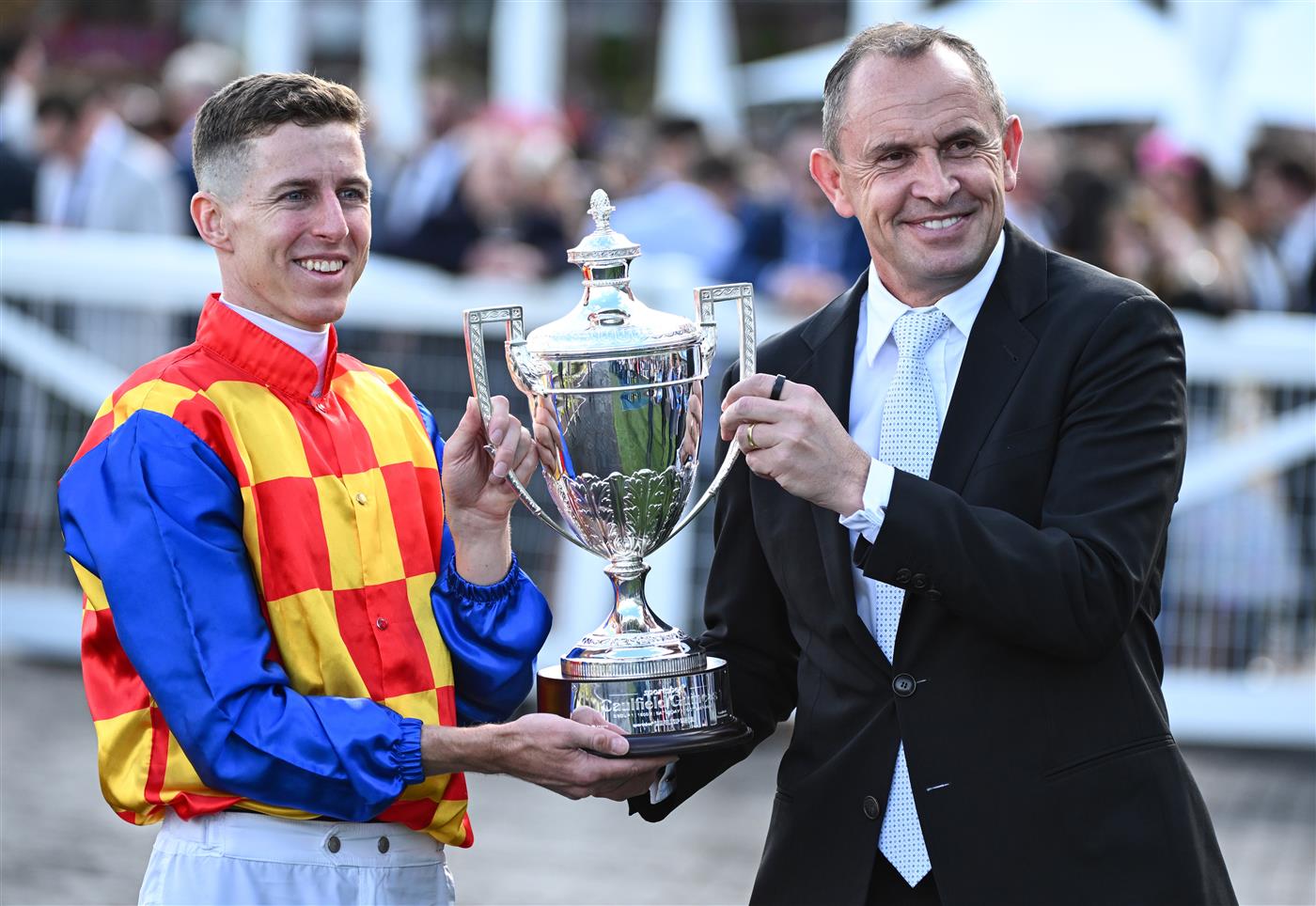 MELBOURNE, AUSTRALIA - OCTOBER 11: Damian Lane poses with Trainer Chris Waller after riding Autumn Boy to win Race 8, the Sportsbet Caulfield Guineas during Melbourne Racing at Caulfield Racecourse on October 11, 2025 in Melbourne, Australia. (Photo by Vince Caligiuri/Getty Images)