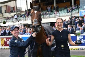 MELBOURNE, AUSTRALIA - OCTOBER 11: Trainer Charlotte Littlefield hugs She's Bulletproof after winning Race 10, the Northwood Plume Stakes. (Getty)