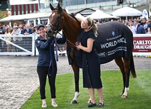 MELBOURNE, AUSTRALIA - OCTOBER 11: Trainer Charlotte Littlefield hugs She's Bulletproof after winning Race 10, the Northwood Plume Stakes. (Getty)