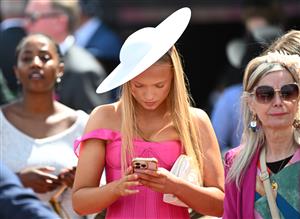 MELBOURNE, AUSTRALIA - OCTOBER 11: General view of racegoers on mobile phone during Melbourne Racing at Caulfield Racecourse on October 11, 2025 in Melbourne, Australia. (Photo by Vince Caligiuri/Getty Images)