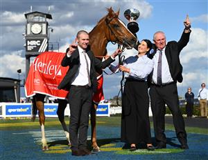 MELBOURNE, AUSTRALIA - OCTOBER 11: Trainer Clayton Douglas, Lydia Rigg-Floyd and Rod Douglas pose with Giga Kick after winning Race 9, the Henley Homes Schillaci Stakes during Melbourne Racing at Caulfield Racecourse on October 11, 2025 in Melbourne, Australia. (Photo by Vince Caligiuri/Getty Images)