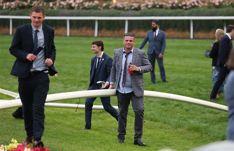 MELBOURNE, AUSTRALIA - OCTOBER 25: Spectators are seen on the track after the Cox Plate Day at Moonee Valley Racecourse on October 25, 2025 in Melbourne, Australia. (Photo by Robert Cianflone/Getty Images)