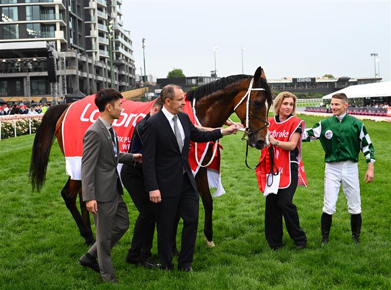 MELBOURNE, AUSTRALIA - OCTOBER 25: James McDonald poses with trainer Chris Waller and owner Jun Zhang representing Yulong after Via Sistina won Race 10 , the Ladbrokes Cox Plate during Cox Plate Day at Moonee Valley Racecourse on October 25, 2025 in Melbourne, Australia. (Photo by Vince Caligiuri/Getty Images)