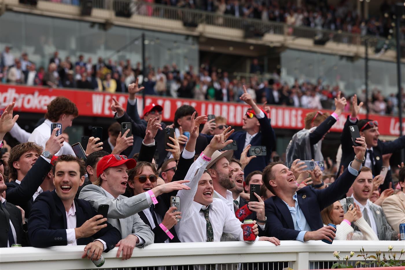 MELBOURNE, AUSTRALIA - OCTOBER 25: Spectators singa along to Daryl Braithwaite as he performs during Cox Plate Day at Moonee Valley Racecourse on October 25, 2025 in Melbourne, Australia. (Photo by Robert Cianflone/Getty Images)