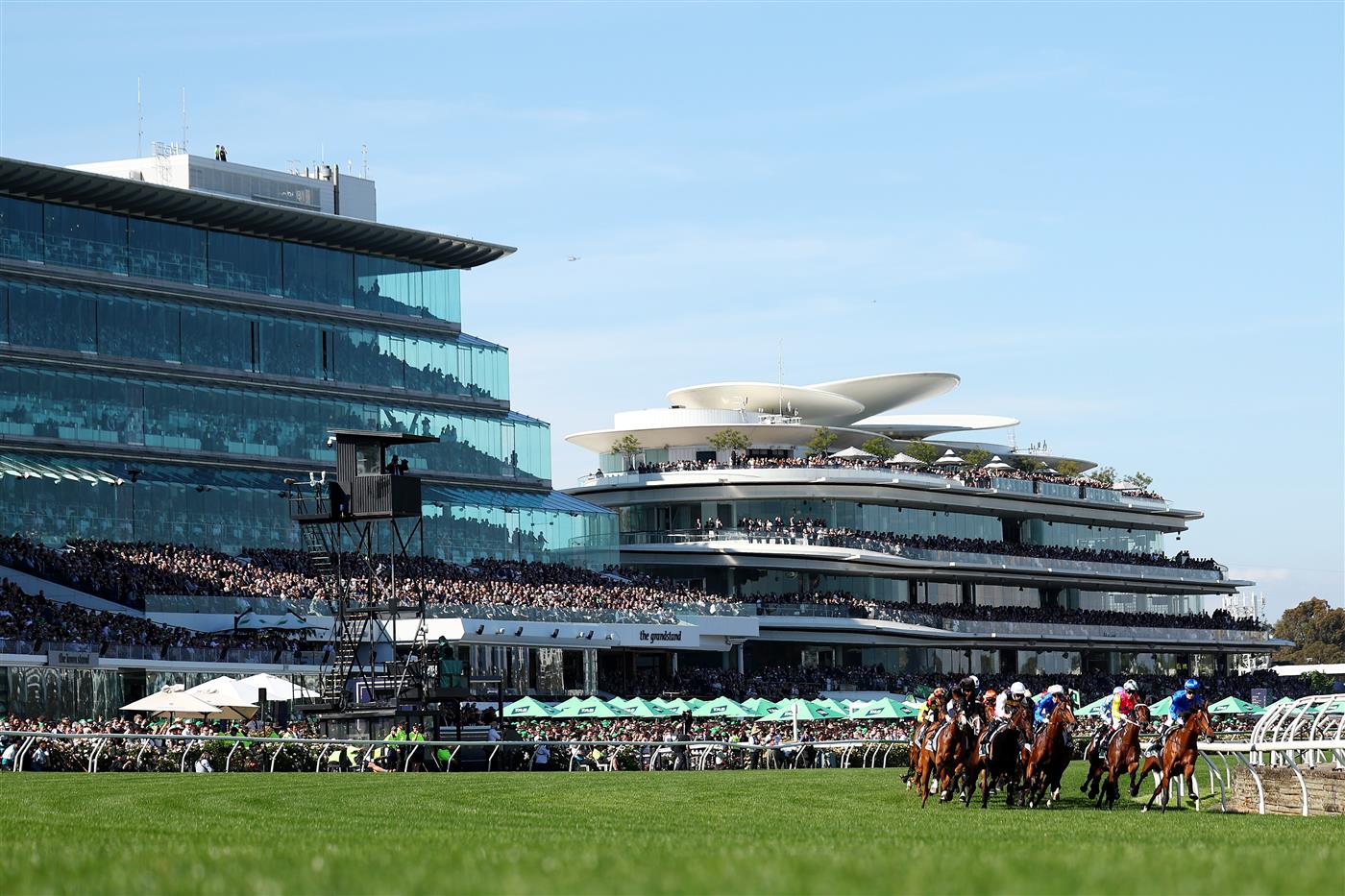 MELBOURNE, AUSTRALIA - NOVEMBER 01: A general view as jockeys ride horses around the first bend in Race 7 the Howden Victoria Derby during Melbourne Racing at Flemington Racecourse on November 01, 2025 in Melbourne, Australia. (Photo by Morgan Hancock/Getty Images)