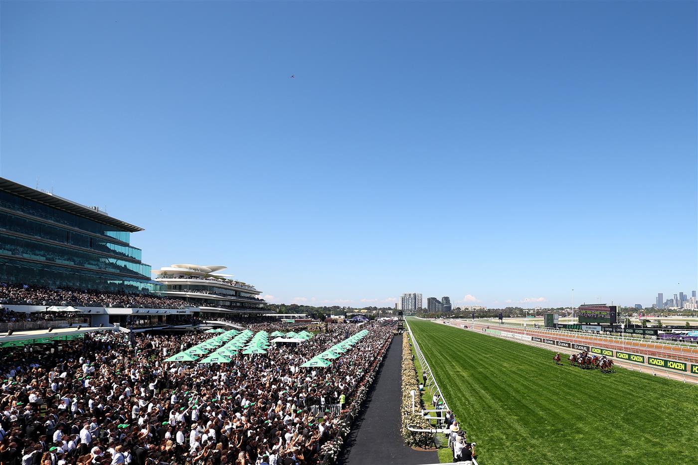 MELBOURNE, AUSTRALIA - NOVEMBER 01: Crowds watch on as Mark Zahra rides Warnie to win race five The Abc Bullion Damien Oliver during Melbourne Racing at Flemington Racecourse on November 01, 2025 in Melbourne, Australia. (Photo by Morgan Hancock/Getty Images)