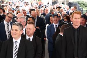 MELBOURNE, AUSTRALIA - NOVEMBER 01: Patrons prepare to enter through the gates ahead of Melbourne Racing at Flemington Racecourse on November 01, 2025 in Melbourne, Australia. (Photo by Morgan Hancock/Getty Images)