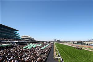 MELBOURNE, AUSTRALIA - NOVEMBER 01: Crowds watch on as Mark Zahra rides Warnie to win race five The Abc Bullion Damien Oliver during Melbourne Racing at Flemington Racecourse on November 01, 2025 in Melbourne, Australia. (Photo by Morgan Hancock/Getty Images)