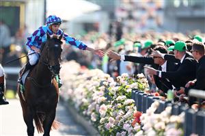 MELBOURNE, AUSTRALIA - NOVEMBER 01: Declan Bates celebrates after riding Pride of Jenni to win race eight the Tab Empire Rose Stakes during Melbourne Racing at Flemington Racecourse on November 01, 2025 in Melbourne, Australia. (Photo by Daniel Pockett/Getty Images)