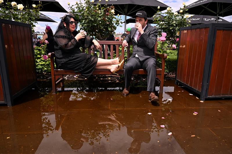 People wait for the start of the Melbourne Cup horse race at the Flemington Racecourse in Melbourne on November 4, 2025. (Photo by William WEST / AFP) / --IMAGE RESTRICTED TO EDITORIAL USE - STRICTLY NO COMMERCIAL USE-- (Photo by WILLIAM WEST/AFP via Getty Images)          