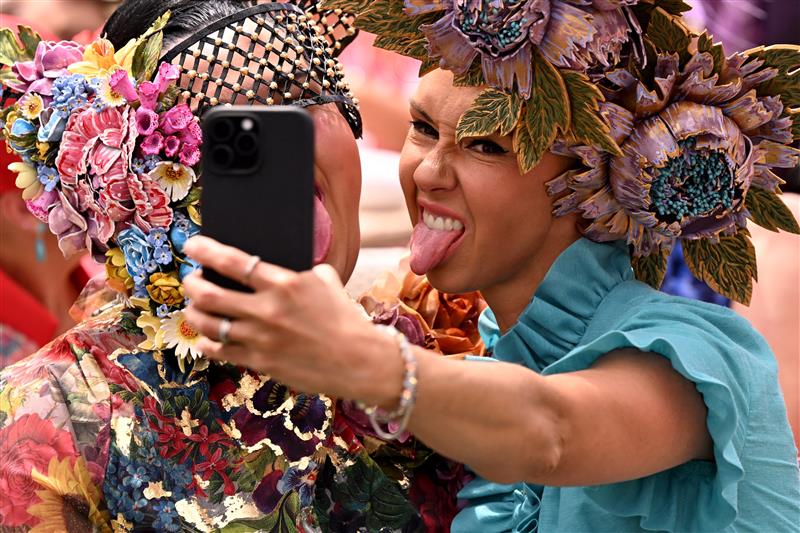 People pose before the running of the Melbourne Cup horse race at the Flemington Racecourse in Melbourne on November 4, 2025. (Photo by William WEST / AFP) / --IMAGE RESTRICTED TO EDITORIAL USE - STRICTLY NO COMMERCIAL USE-- (Photo by WILLIAM WEST/AFP via Getty Images)          