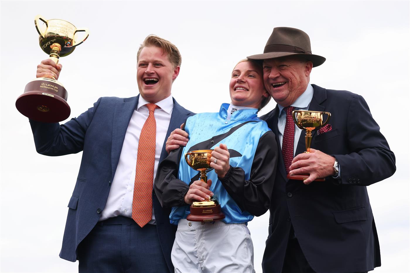 MELBOURNE, AUSTRALIA - NOVEMBER 04: Jamie Melham (C) celebrates with co trainers Tony McEvoy (R) and Calvin McEvoy after riding Half Yours during Melbourne Cup Day at Flemington Racecourse on November 04, 2025 in Melbourne, Australia. (Photo by Daniel Pockett/Getty Images)