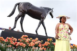 MELBOURNE, AUSTRALIA - NOVEMBER 04: A racegoer poses for a photo during Melbourne Cup Day at Flemington Racecourse on November 04, 2025 in Melbourne, Australia. (Photo by Morgan Hancock/Getty Images)