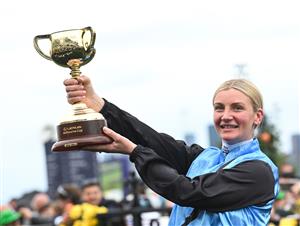 MELBOURNE, AUSTRALIA - NOVEMBER 04: Jamie Melham poses with the trophy after riding Half Yours to win Race 7, the Lexus Melbourne Cup during Melbourne Cup Day at Flemington Racecourse on November 04, 2025 in Melbourne, Australia. (Photo by Vince Caligiuri/Getty Images)