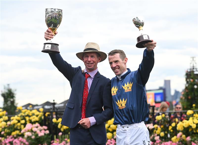 MELBOURNE, AUSTRALIA - NOVEMBER 06: John Allen poses with trainer Thomas Carberry with the trophy after riding Strictly Business to win Race 8, the Crown Oaks during Oaks Day at Flemington Racecourse on November 06, 2025 in Melbourne, Australia. (Photo by Vince Caligiuri/Getty Images)