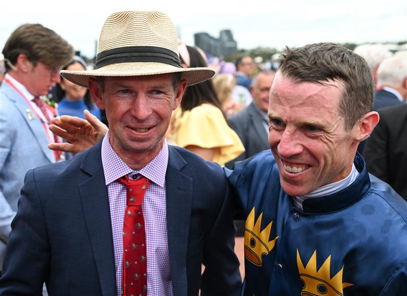 MELBOURNE, AUSTRALIA - NOVEMBER 06: John Allen poses with trainer Thomas Carberry after riding Strictly Business to win Race 8, the Crown Oaks during Oaks Day at Flemington Racecourse on November 06, 2025 in Melbourne, Australia. (Photo by Vince Caligiuri/Getty Images)