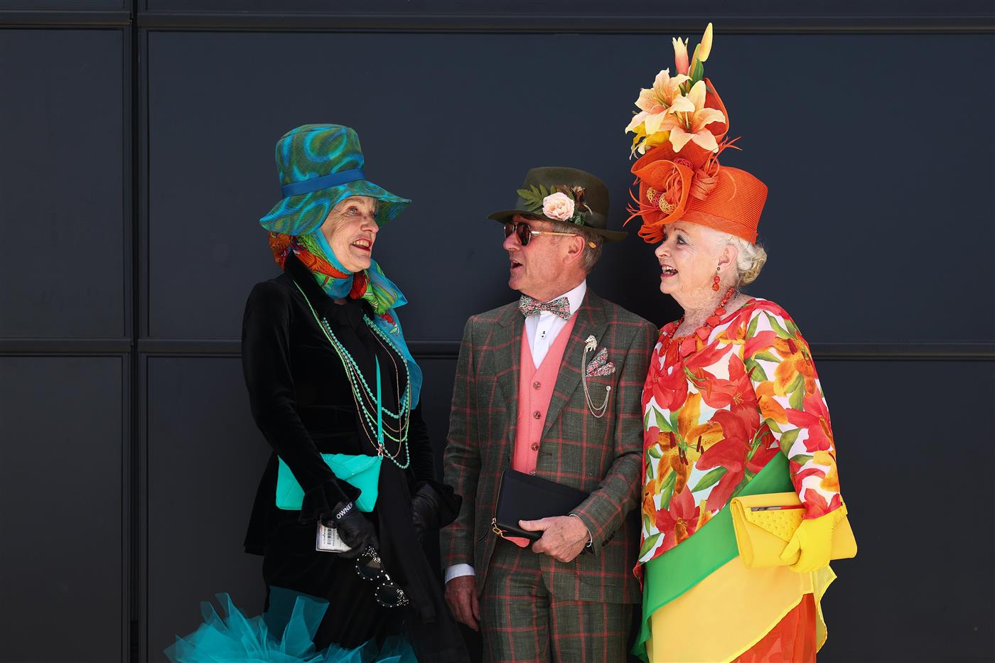 MELBOURNE, AUSTRALIA - NOVEMBER 06: Race goers Suzanne Suzette, John Morrow and Lynne Rait pose for a photograph during Oaks Day at Flemington Racecourse on November 06, 2025 in Melbourne, Australia. (Photo by Daniel Pockett/Getty Images)