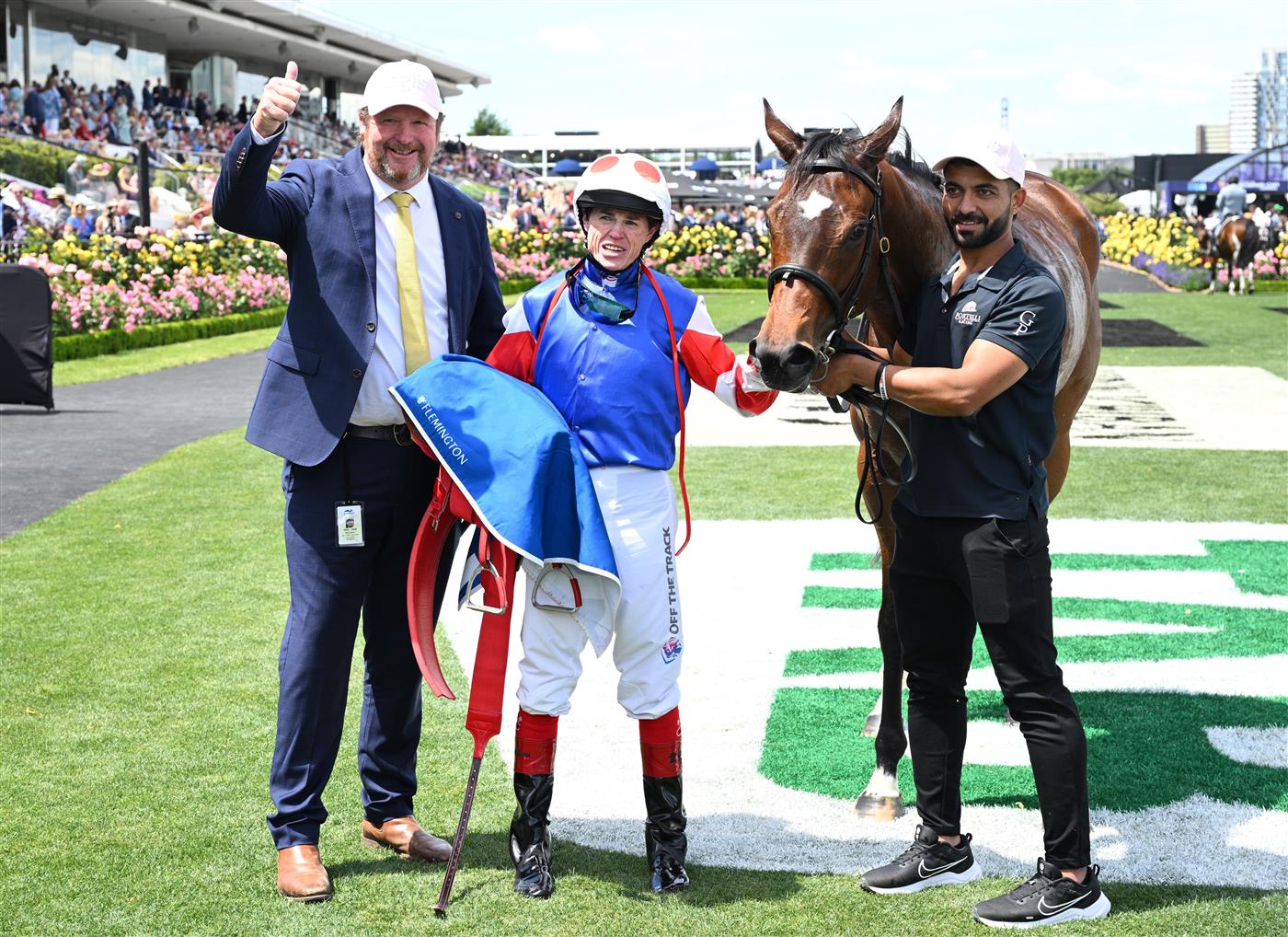 MELBOURNE, AUSTRALIA - NOVEMBER 06: Craig Williams poses with trainer Gary Portelli after riding Verona Rose to win Race 3, the Inglis Bracelet during Oaks Day at Flemington Racecourse on November 06, 2025 in Melbourne, Australia. (Photo by Vince Caligiuri/Getty Images)