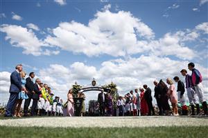 MELBOURNE, AUSTRALIA - NOVEMBER 06: Jockeys form a guard of honour for children and their families after the running of Race Four the Good Friday Appeal Trophy during Melbourne Racing at Flemington Racecourse on November 06, 2025 in Melbourne, Australia. (Photo by Morgan Hancock/Getty Images)
