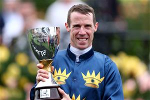 MELBOURNE, AUSTRALIA - NOVEMBER 06: John Allen poses with the Crown Oaks Trophy after riding #7 Strictly Business to win race eight the Crown Oaks during Oaks Day at Flemington Racecourse on November 06, 2025 in Melbourne, Australia. (Photo by Josh Chadwick/Getty Images)