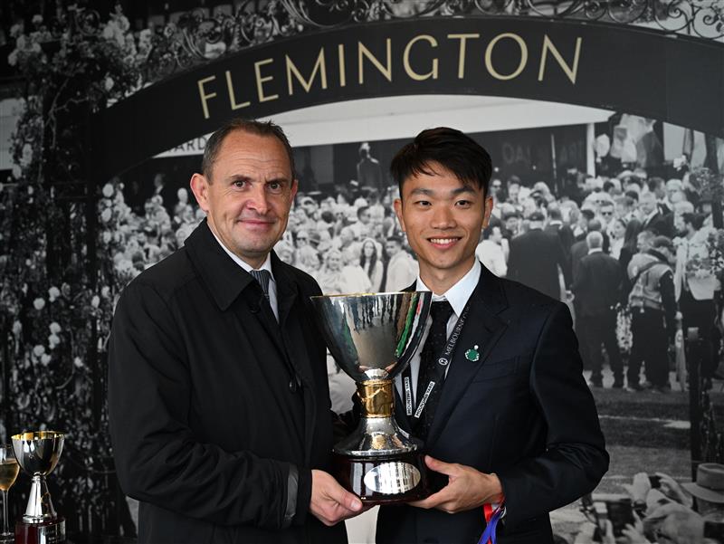 MELBOURNE, AUSTRALIA - NOVEMBER 08: Trainer Chris Waller and Jun Zhang pose with the champions trophy after Via Sistina won Race 8, the Tab Champions Stakes  during Champions Day at Flemington Racecourse on November 08, 2025 in Melbourne, Australia. (Photo by Vince Caligiuri/Getty Images)