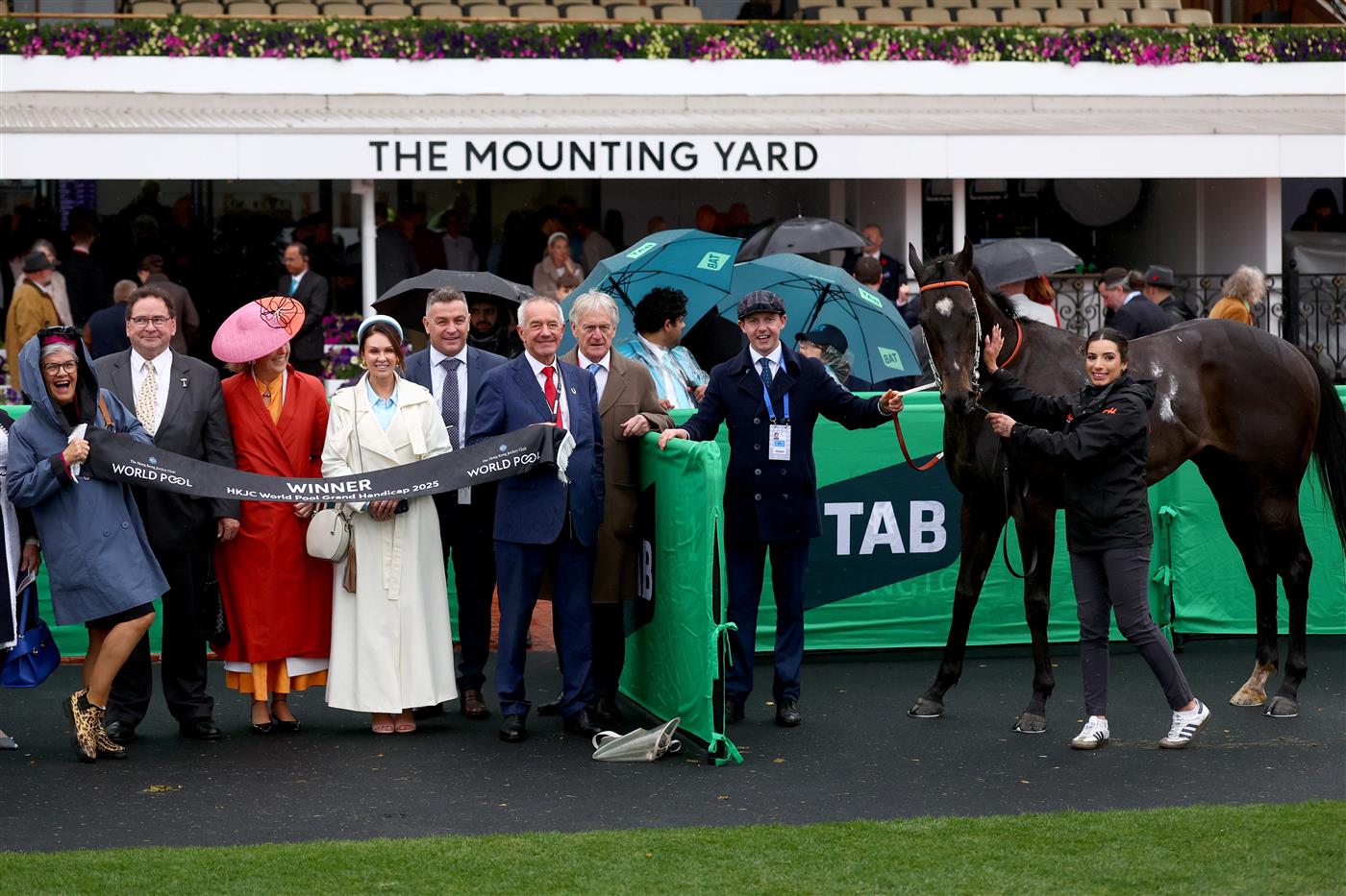 MELBOURNE, AUSTRALIA - NOVEMBER 08: Connections of Grand Larceny pose after Ben Melham rode Grand Larceny to win Race 9, the HKJC World Pool Grand Handicap during Champions Day at Flemington Racecourse on November 08, 2025 in Melbourne, Australia. (Photo by Josh Chadwick/Getty Images)