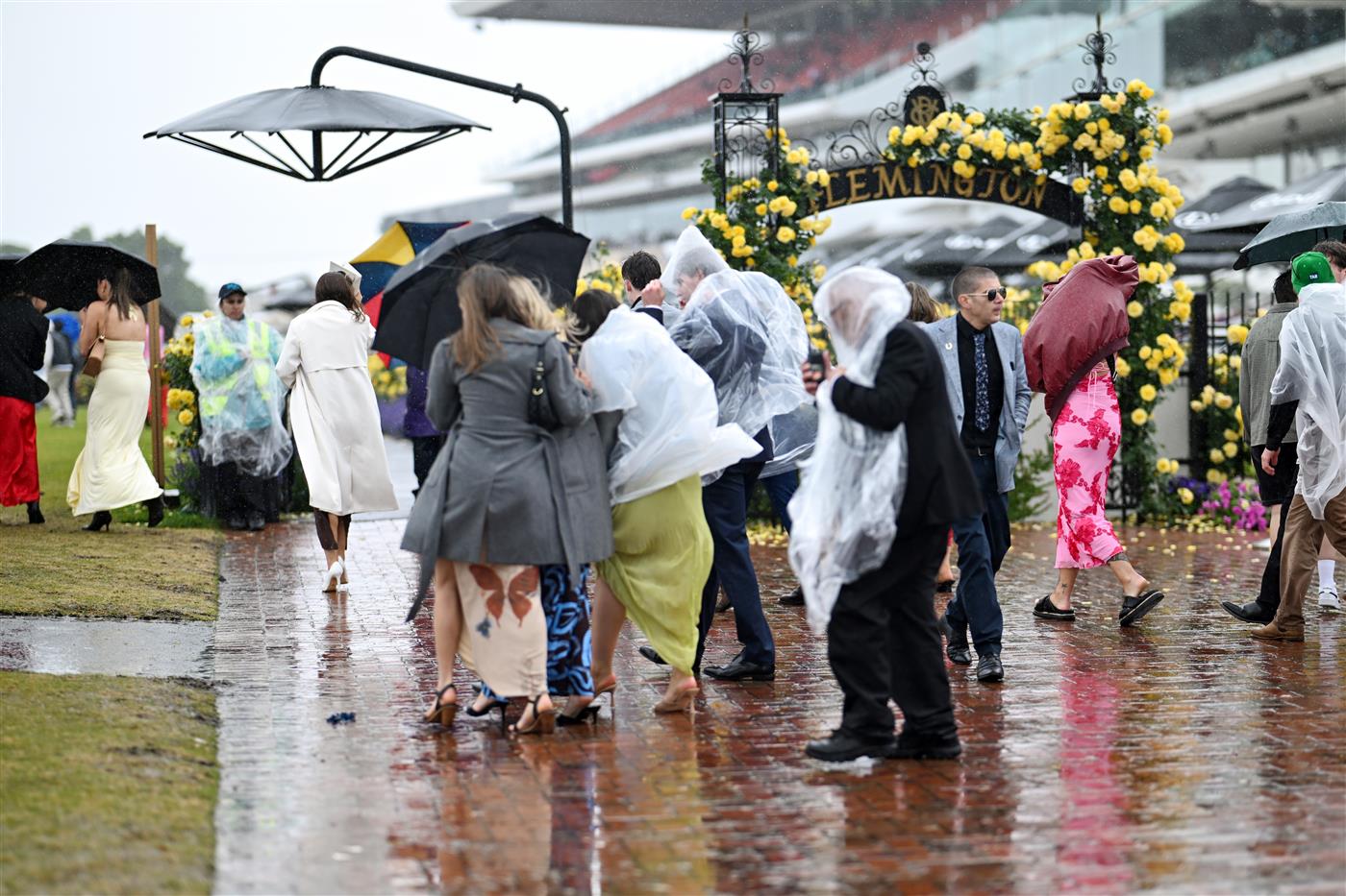 MELBOURNE, AUSTRALIA - NOVEMBER 08: A general view of racegoers in the rain during 2025 Stakes Day at Flemington Racecourse on November 08, 2025 in Melbourne, Australia. (Photo by Wendell Teodoro/Getty Images)