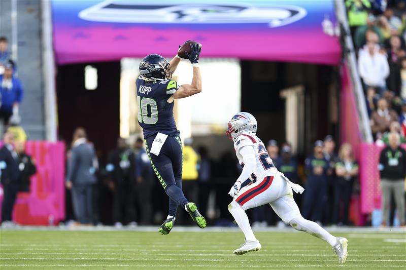 SANTA CLARA, CALIFORNIA - FEBRUARY 8: Cooper Kupp #10 of the Seattle Seahawks makes a catch in front of Marcus Jones #25 of the New England Patriots during the second quarter of the NFL Super Bowl LX football game, at Levi