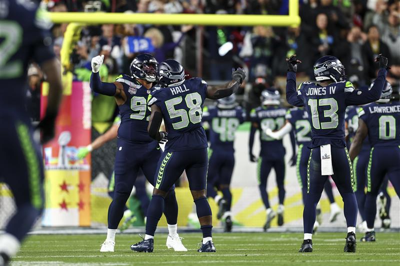SANTA CLARA, CALIFORNIA - FEBRUARY 8: Derick Hall #58 of the Seattle Seahawks celebrates after forcing a fumble during the third quarter of the NFL Super Bowl LX football game against the New England Patriots, at Levi