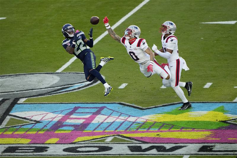 SANTA CLARA, CALIFORNIA - FEBRUARY 08: Christian Gonzalez #0 of the New England Patriots breaks up a pass intended for for Rashid Shaheed #22 of the Seattle Seahawks during the second quarter in Super Bowl LX at Levi