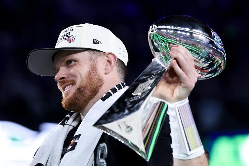 SANTA CLARA, CALIFORNIA - FEBRUARY 08: Sam Darnold #14 of the Seattle Seahawks celebrates with the Vince Lombardi Trophy after winning Super Bowl LX against the New England Patriots at Levi