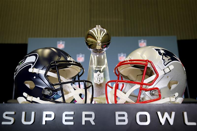 SAN JOSE, CALIFORNIA - FEBRUARY 02: The Vince Lombardi Trophy is framed by the Seattle Seahawks and New England Patriots helmets during Super Bowl LX Opening Night at San Jose McEnery Convention Center on February 02, 2026 in San Jose, California. (Photo by Chris Graythen/Getty Images)