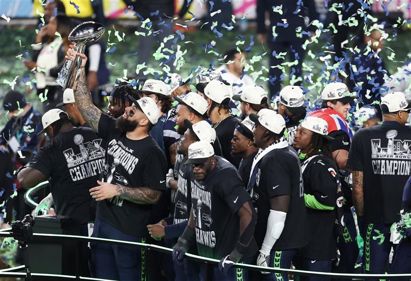 Seattle Seahawks celebrate with the Vince Lombardi Trophy after winning Super Bowl LX against the New England Patriots
